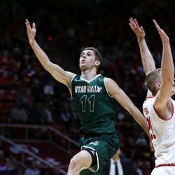 Utah Valley Wolverines guard Conner Toolson (11) lays it up behind Utah Utes forward Tyler Rawson (21) during the game at the Huntsman Center in Salt Lake City on Tuesday, Dec. 6, 2016.