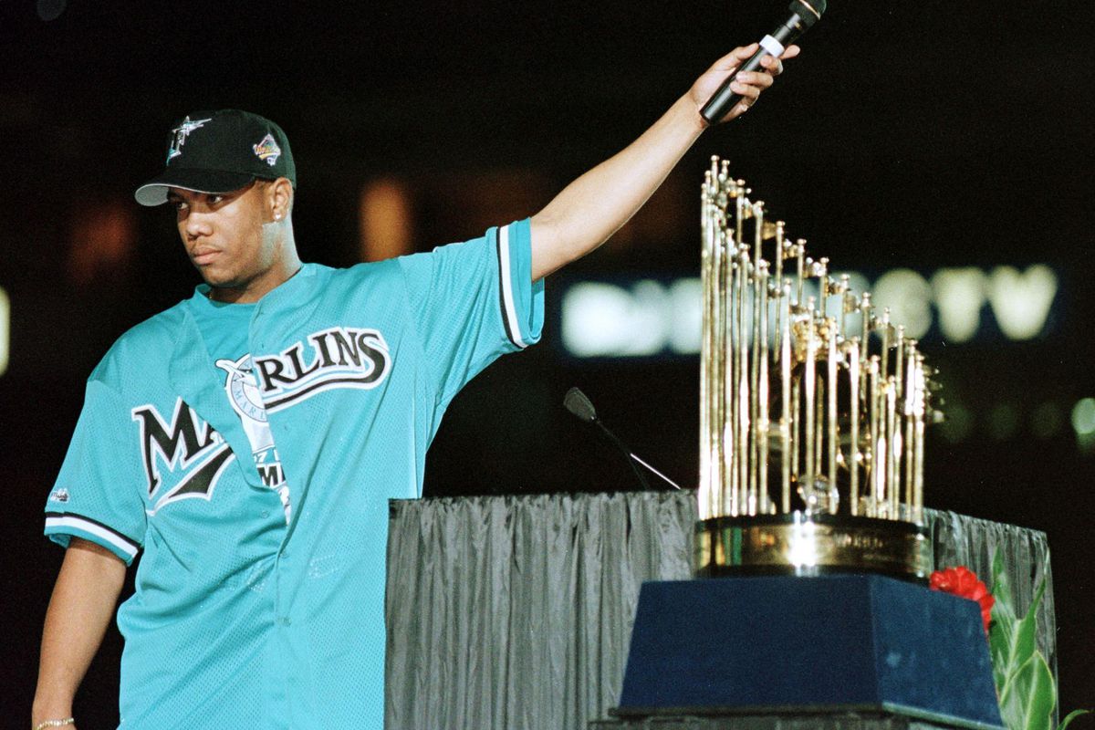 Florida Marlin pitcher and World Series Most Valuable Player Livan Hernandez holds the microphone to the crowd as they cheer at a rally held for the Florida Marlins 28 October at Pro Player Stadium in Miami, Florida. The Marlins Beat the Cleveland Indians of the American League in a best of seven-series