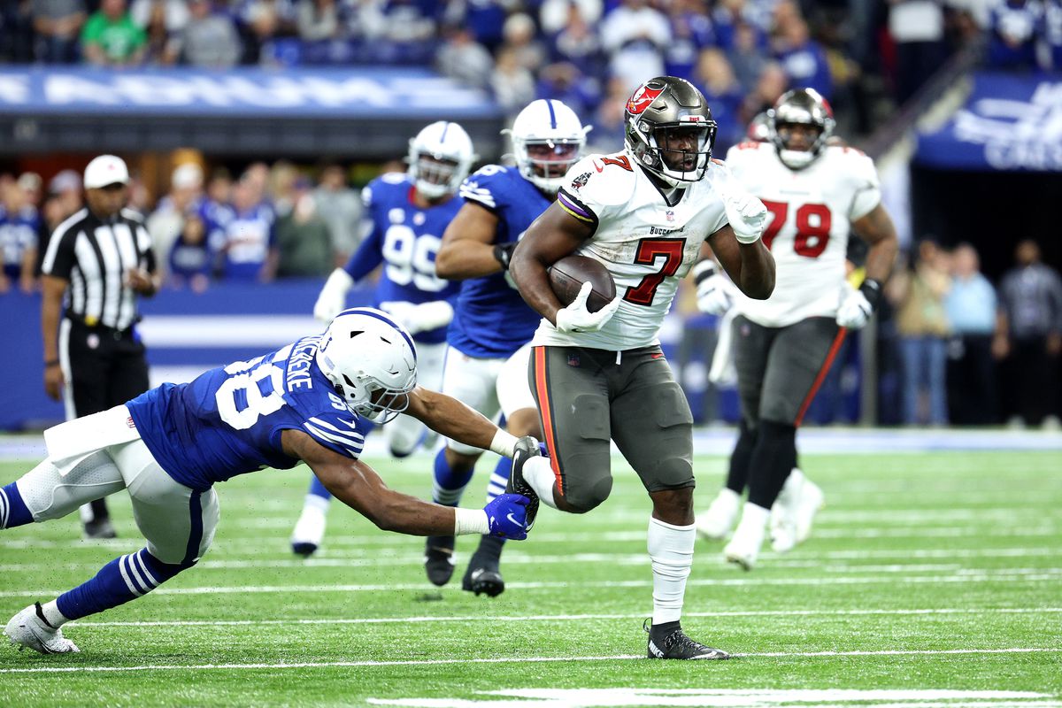 Leonard Fournette #7 of the Tampa Bay Buccaneers carries the ball down the field as Bobby Okereke #58 of the Indianapolis Colts defends in the fourth quarter of the game at Lucas Oil Stadium on November 28, 2021 in Indianapolis, Indiana.