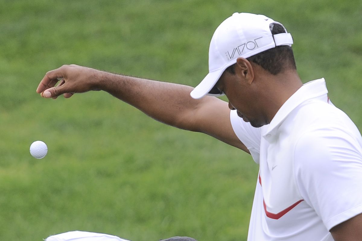 Tiger Woods takes a drop during Saturday's career-worst round.