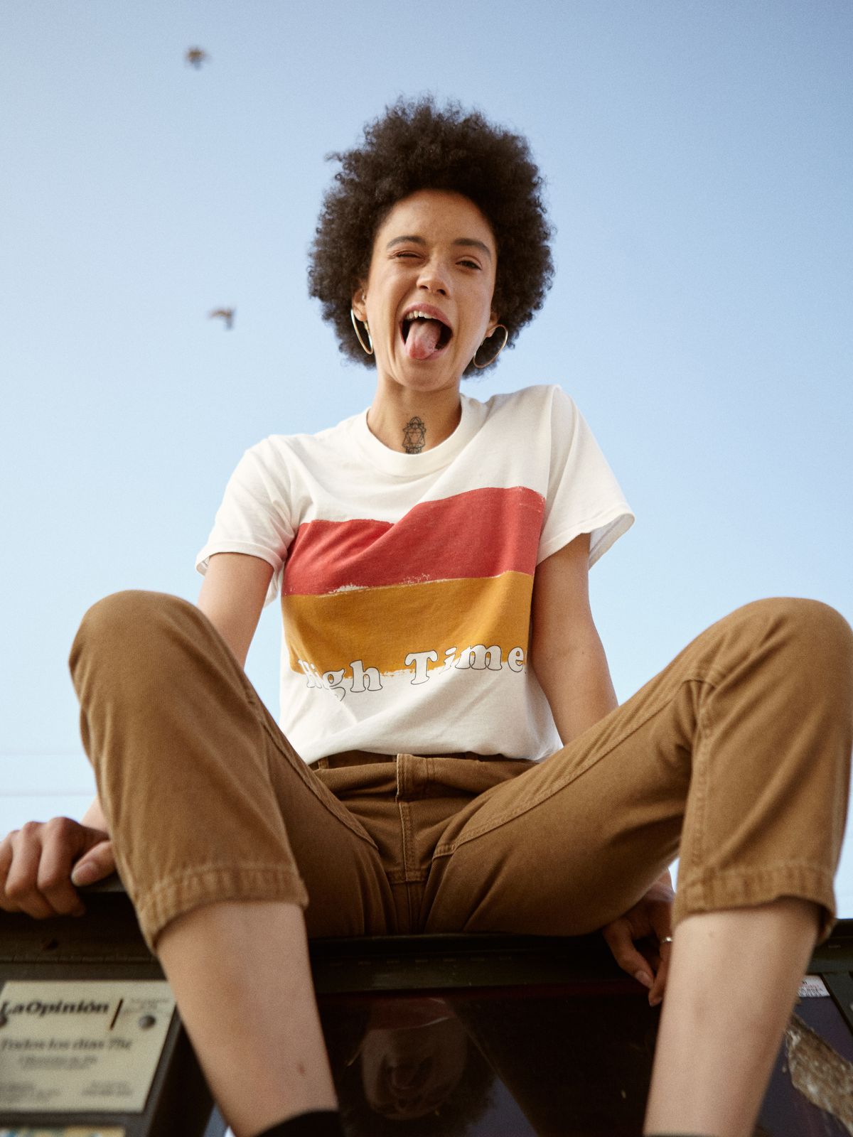 model with afro in t-shirt and chino pants 