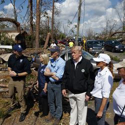 FEMA director Brock Long, left, talks with from left, Homeland Security Secretary Kirstjen Nielsen, Florida Gov. Rick Scott, President Donald Trump, first lady Melania Trump and Margo Anderson, Mayor of Lynn Haven, right, as they tour a neighborhood affected by Hurricane Michael, Monday, Oct. 15, 2018, in Lynn Haven, Fla. (AP Photo/Evan Vucci)