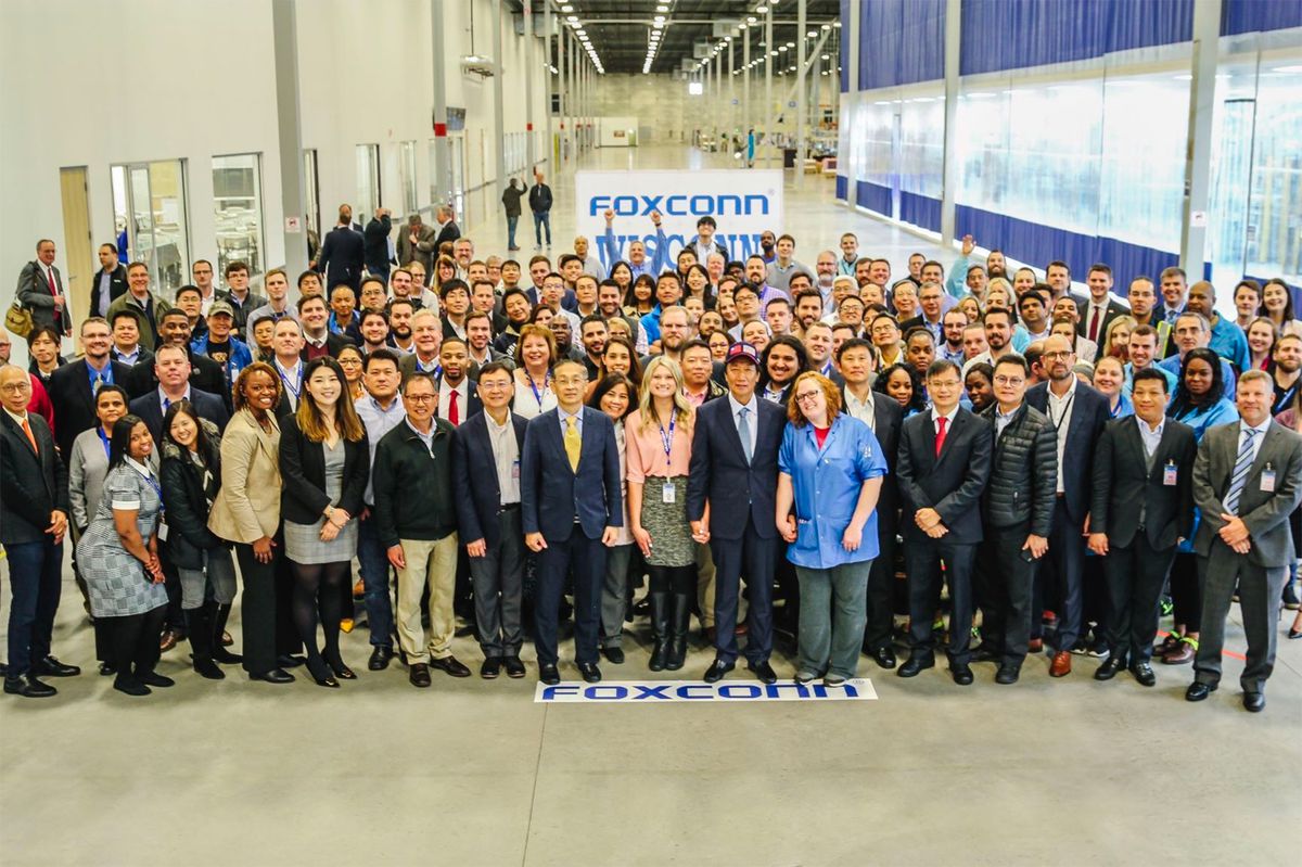 Foxconn employees pose for a group photo.