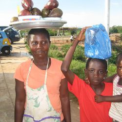 Children sell food at a highway rest stop outside of Accra, Ghana