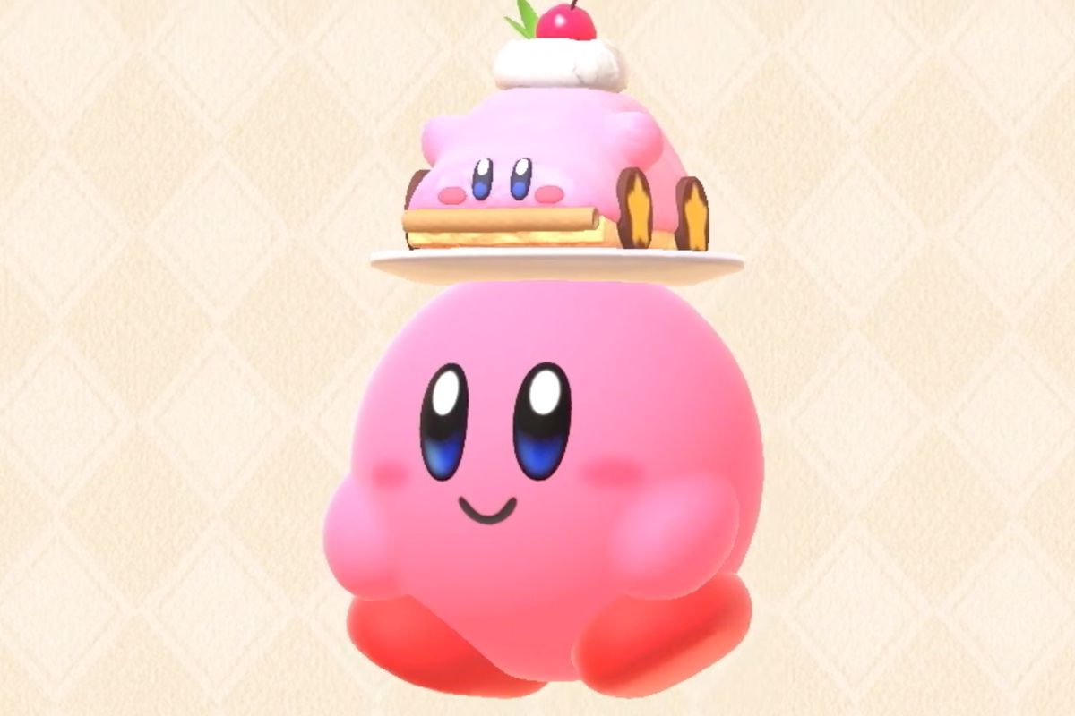 Kirby, wearing a cake shaped like a car shaped like Kirby as a hat, in Kirby’s Dream Buffet