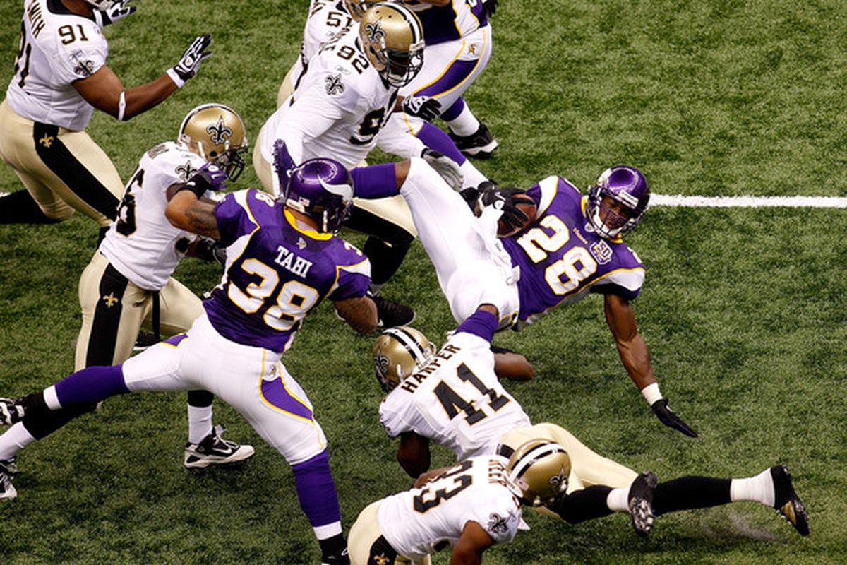 NEW ORLEANS - SEPTEMBER 09:  Adrian Peterson #28 of the Minnesota Vikings is tackled by Roman Harper #41 of the New Orleans Saints at Louisiana Superdome on September 9 2010 in New Orleans Louisiana.  (Photo by Chris Graythen/Getty Images)