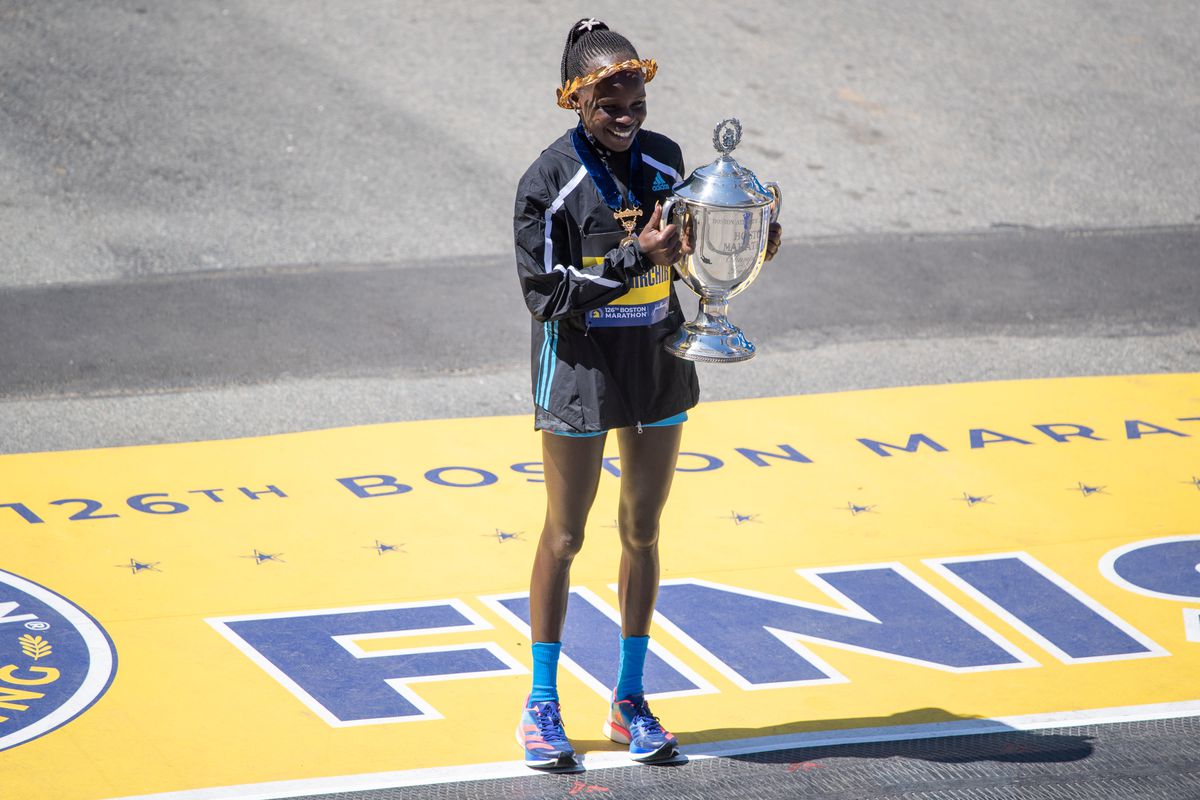 Peres Jepchirchir of Kenya, the winner of the women’s professional division of the Boston Marathon, poses with her trophy on April 18, 2022 on Boylston Street in Boston, MA. Jepchirchir finished with a time of 2:21:01.