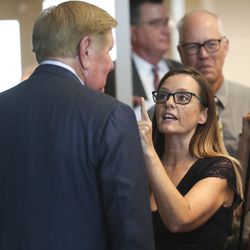 Kem Gardner, left, talks with an upset Candi Huff, of the Epilepsy Association of Utah, after a broad coalition of Utah community leaders announced its opposition to Utah's medical marijuana ballot initiative during a press conference at the Utah State Office Building in Salt Lake City on Thursday, Aug. 23, 2018.