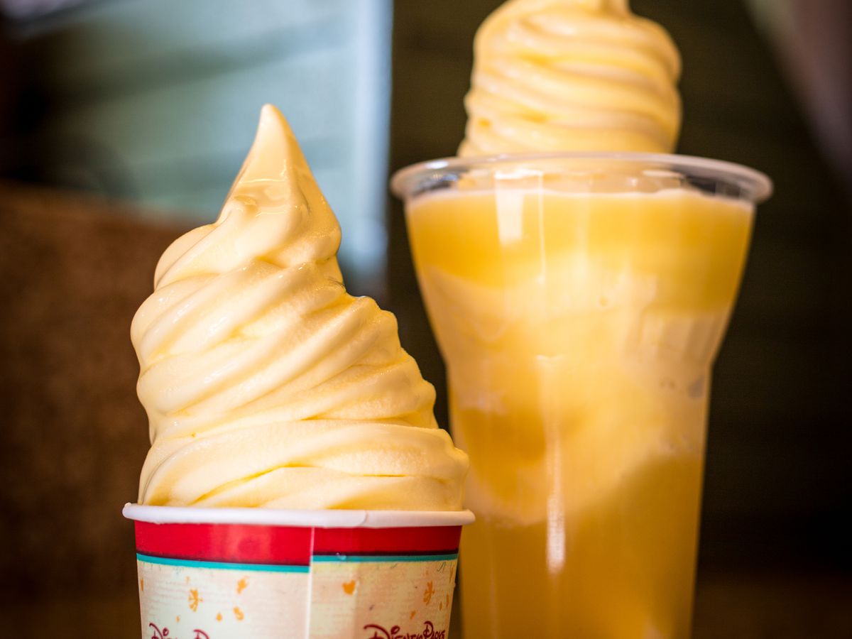 Two soft serve treats, one in a cup and the other topping a drink. 