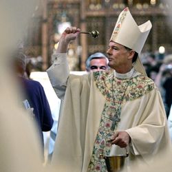 In this March 14, 2007, file photo, Bishop-Designate John Wester blesses church-goers prior to his installation in Salt Lake City. Santa Fe Archbishop John Wester says the upcoming release a movie detailing the Boston Globe's 2002 investigation into the church's cover-up of clergy abuse may bring up "horrific memories" for New Mexico victims. High-ranking leaders of the Catholic church have sent talking points to U.S. dioceses in advance of the wide release of "Spotlight." The Boston Globe reports the U.S. Conference of Catholic Bishops formulated the guidance, complete with statistics, in September in anticipation of the film's Nov. 20 U.S. release. (AP Photo/Douglas C. Pizac, File)
