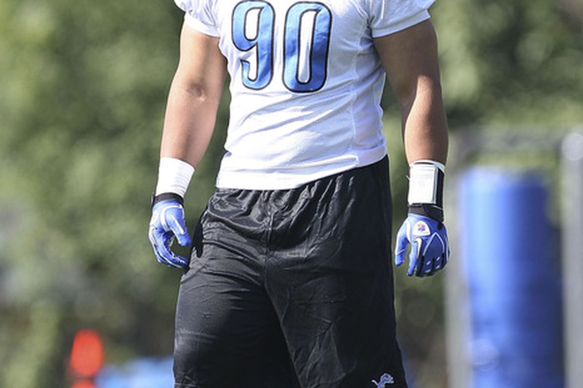 ALLEN PARK, MI - JULY 30:  Ndamukong Suh #90 of the Detroit Lions takes a break during training camp at the Lions facility on July 30, 2011 in Allen Park, Michigan.  (Photo by Leon Halip/Getty Images)