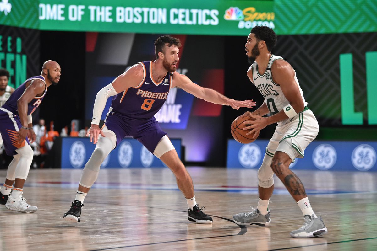 Frank Kaminsky of the Phoenix Suns plays defense on Jayson Tatum of the Boston Celtics on July 26, 2020 in Orlando, Florida at Visa Athletic Center at ESPN Wide World of Sports.