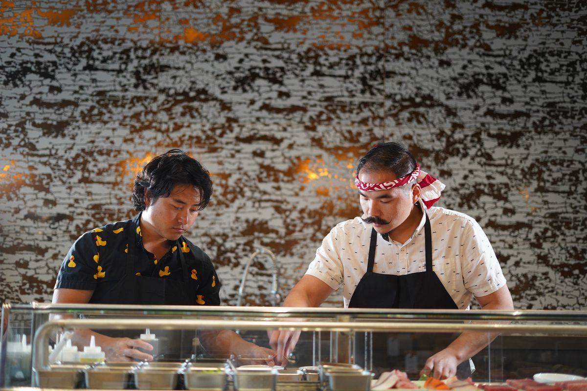 Chefs Daniel Lee and Patrick Pham working at the sushi chefs’ table.