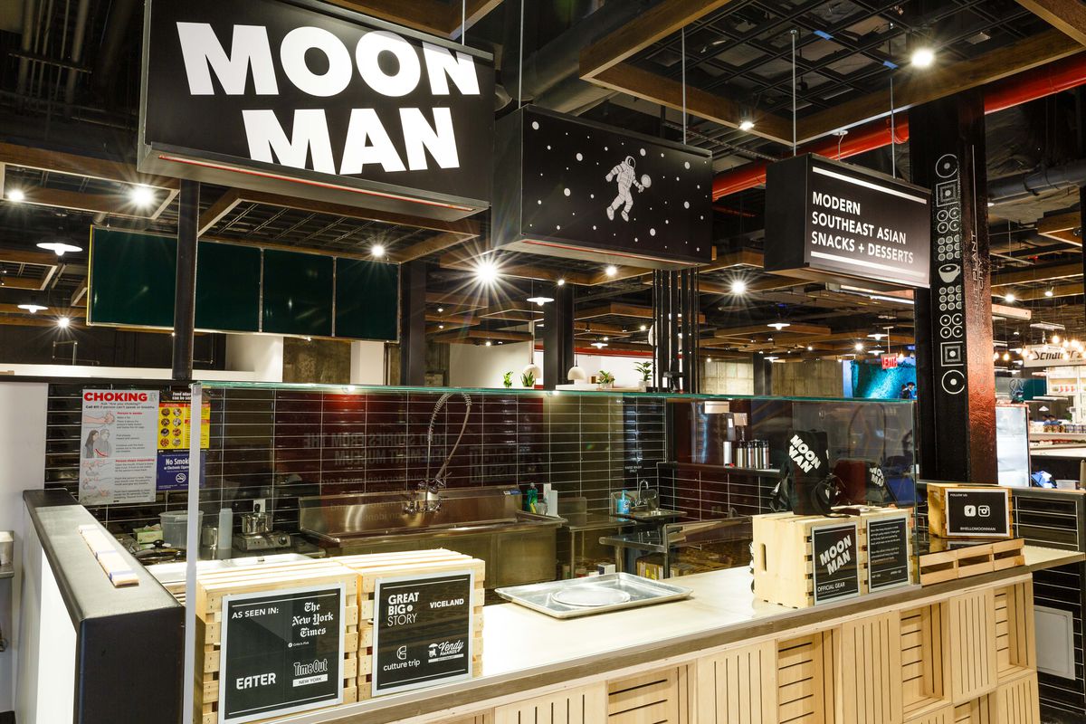 A black sign displays “Moon Man” with white lettering.