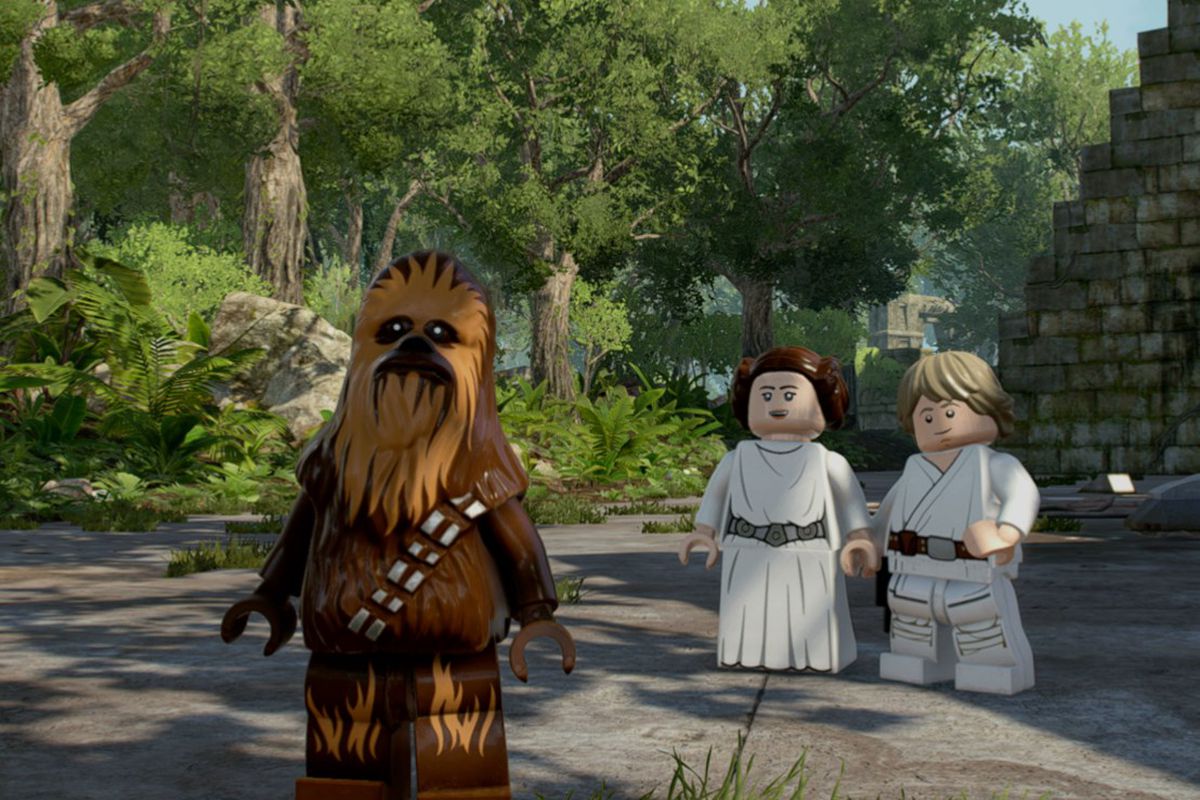 Lego Chewbacca stands in front of Leia and Luke