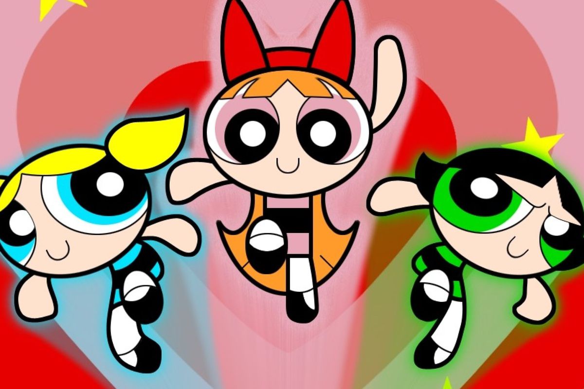 Three girls in blue, pink, and green matching outfits flying in front of red heart background.
