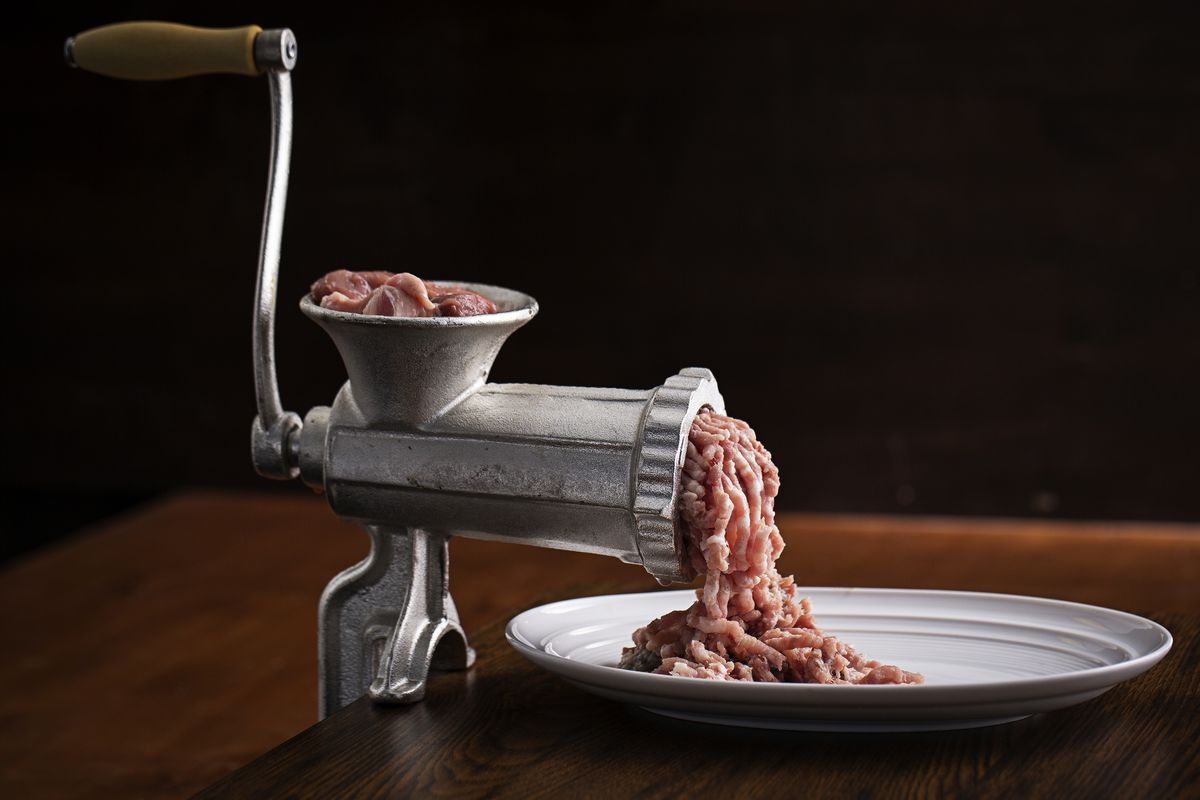 WASHINGTON, DC-May 6: Hand-cranked meat grinder with pork meat