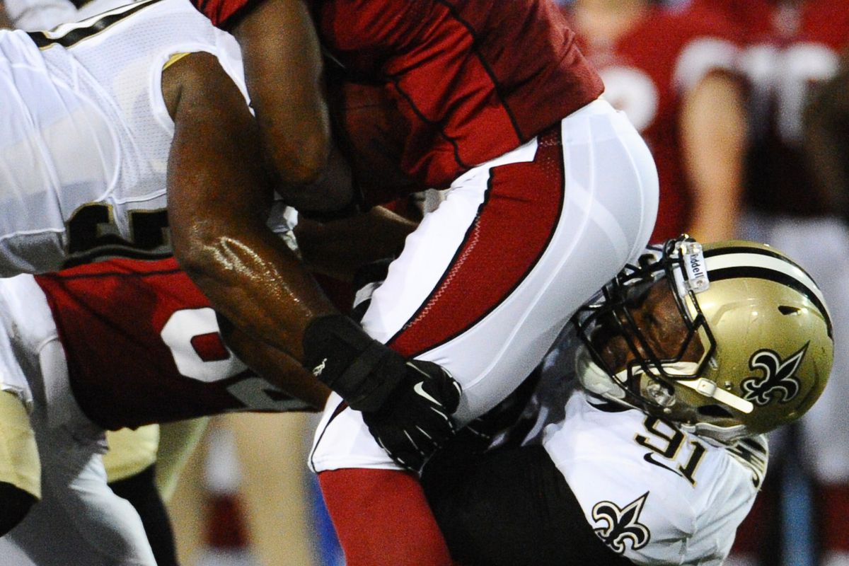Aug 5, 2012; Canton, OH, USA; Arizona Cardinals running back Alfonso Smith (46) is tackled by New Orleans Saints defensive end Will Smith (91) during the first half of a preseason game at Fawcett Stadium. Mandatory Credit: Tim Fuller-US PRESSWIRE