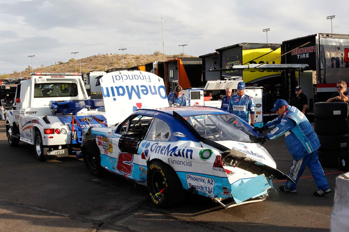 The car of Elliott Sadler is towed to the garage after a crash during the NASCAR Nationwide Series Wypall 200 at Phoenix International Raceway.