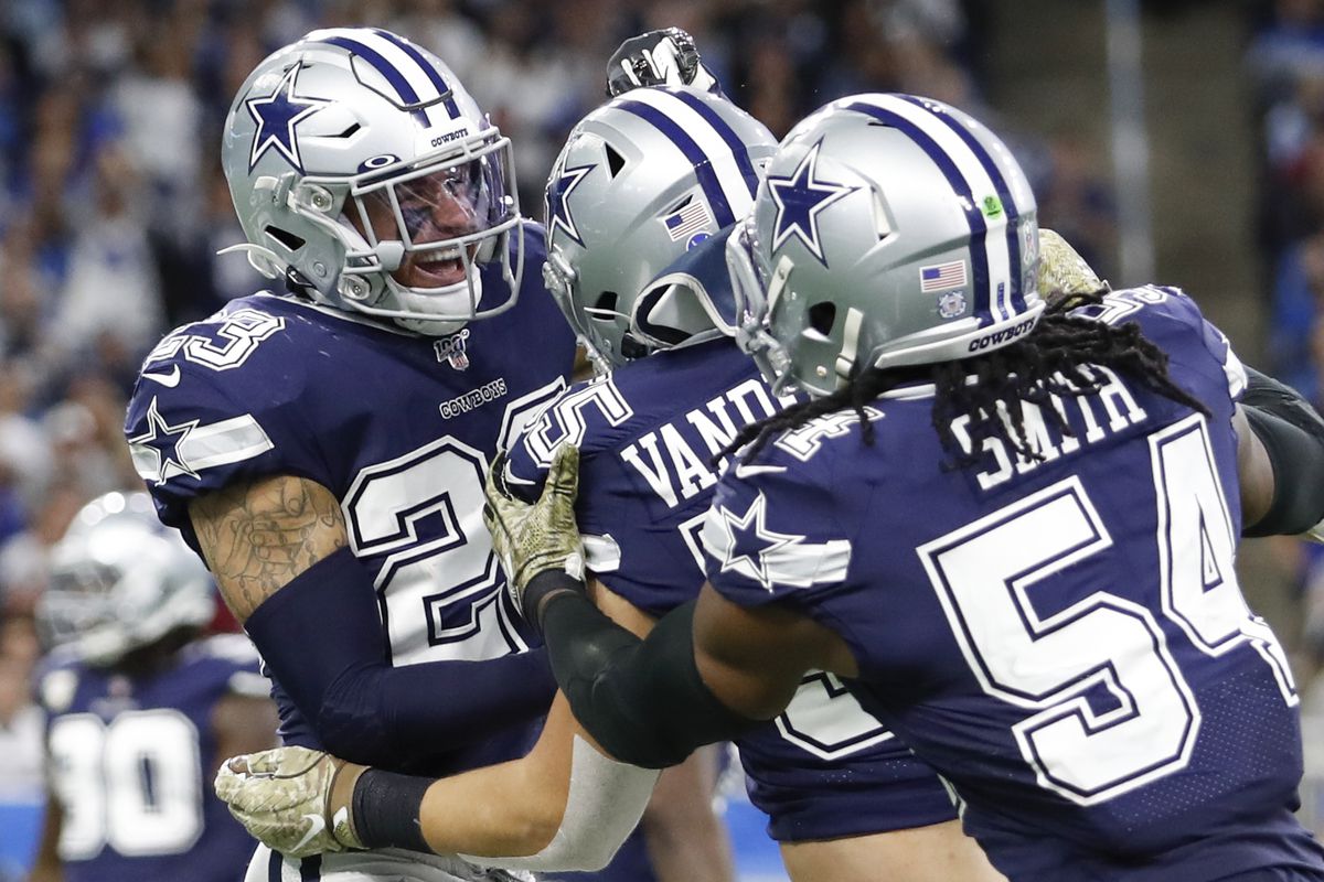 Cowboys defensive back Darian Thompson celebrates with outside linebacker Leighton Vander Esch and middle linebacker Jaylon Smith during the second quarter against the Lions at Ford Field.