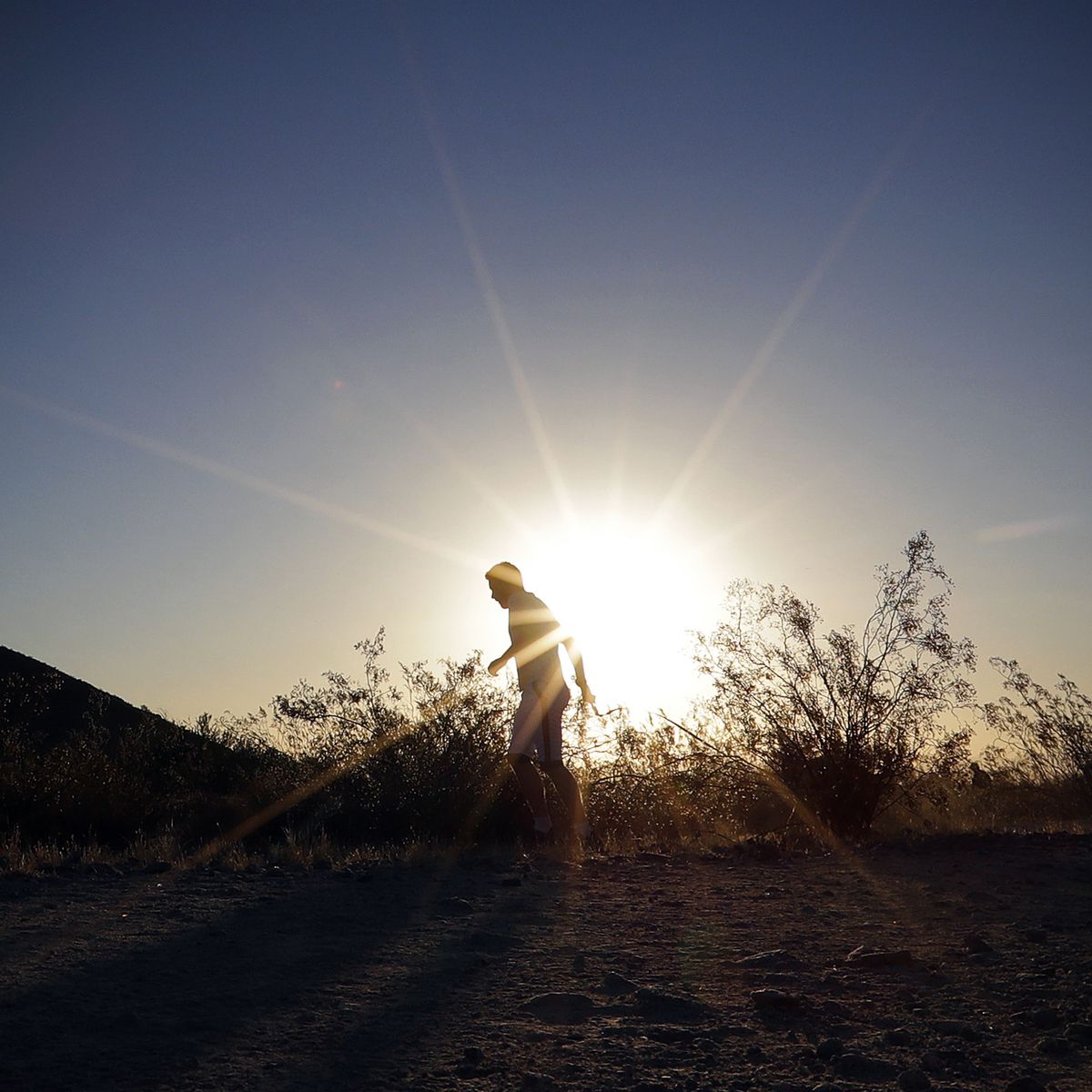 A man runs through section of South Mountain Park at sunrise to avoid the excessive heat in Phoenix.