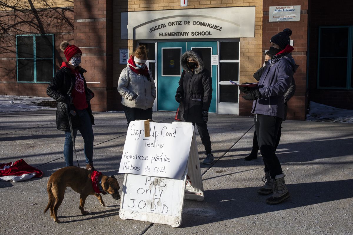 Chicago Teachers Union members stand outside Josefa Ortiz De Dominguez Elementary School at 3000 S. Lawndale Ave. on the Southwest Side, canvasing and attempting to sign Chicago Public Schools students up for COVID-19 testing, Monday morning, Jan. 10, 2022.