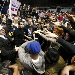 Supporters of Republican presidential candidate Donald Trump, left, face off with protesters after a rally on the campus of the University of Illinois-Chicago was cancelled due to security concerns Friday, March 11, 2016, in Chicago. 