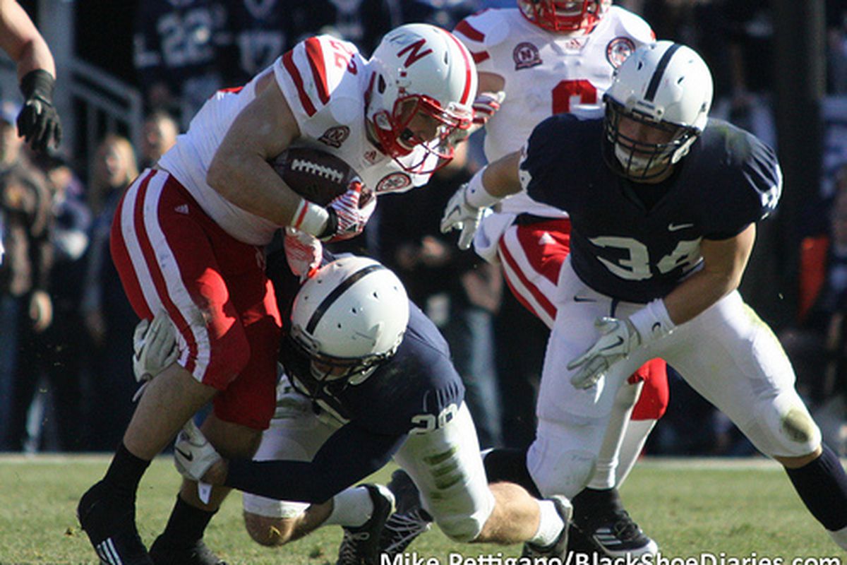 Rex Burkhead (22) tackled during last year's win over Penn State. (Photo: <a href="http://www.flickr.com/photos/mikepettigano/6341949906/in/set-72157627996477069/">Mike Pettigano / BlackShoeDiaries.com</a>)