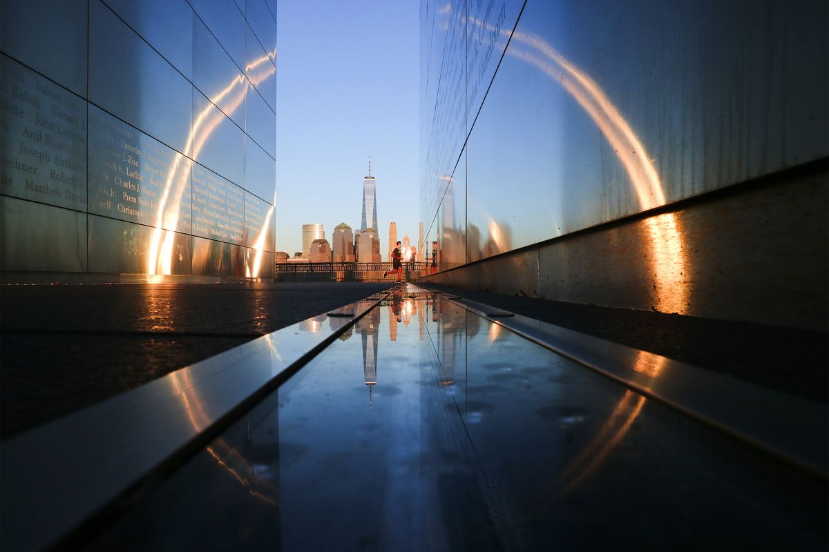 The sun sets on the skyline of lower Manhattan and One World Trade Center in New York City seen from the 9/11 Empty Sky Memorial in Liberty State Park in New Jersey.