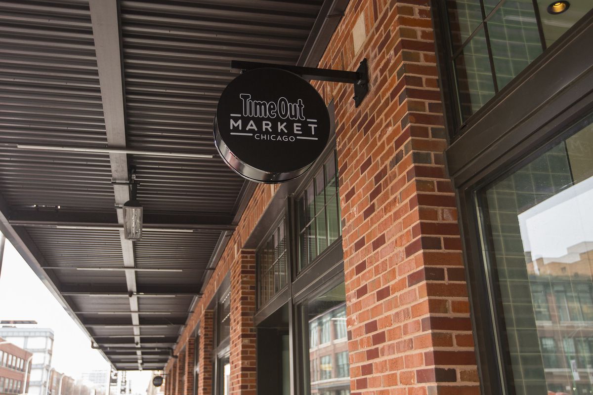 The outside of a food hall with a sign reading “Time Out Market.”