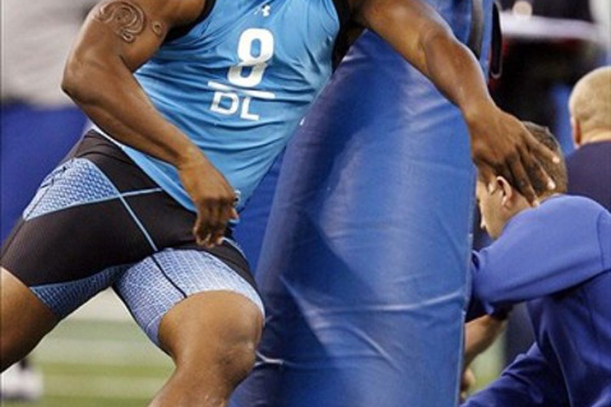 Feb 27, 2012; Indianapolis, IN, USA; North Carolina Tar Heels defensive lineman Quinton Coples hits the tackling dummy during the NFL Combine at Lucas Oil Stadium. Mandatory Credit: Brian Spurlock-US PRESSWIRE