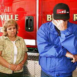 Debbie Sparks and Steven Moore, both EMTs, discuss on May 9 the elementary school bombing. Both had family members in the building during the crisis.