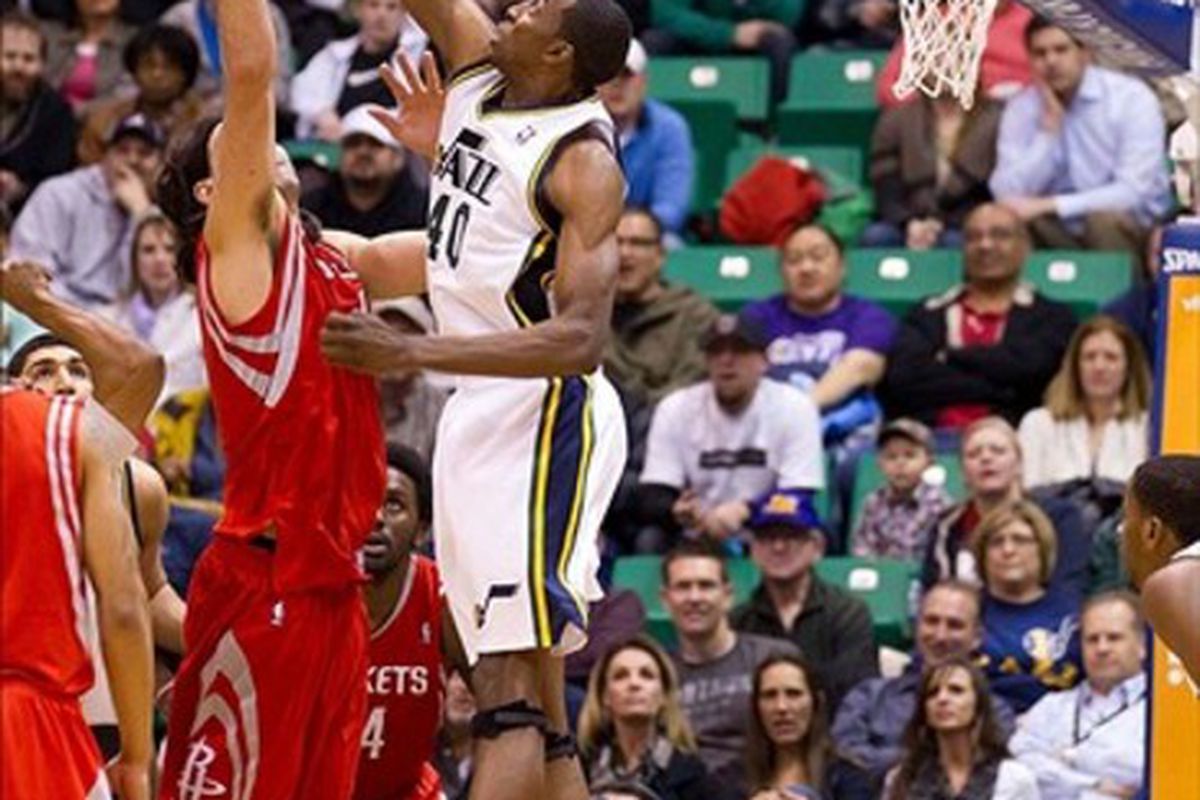 February 29, 2012; Salt Lake City, UT, USA; Utah Jazz small forward Jeremy Evans (40) and Houston Rockets power forward Luis Scola (4) battle for a rebound during the first half at Energy Solutions Arena. Mandatory Credit: Russ Isabella-US PRESSWIRE