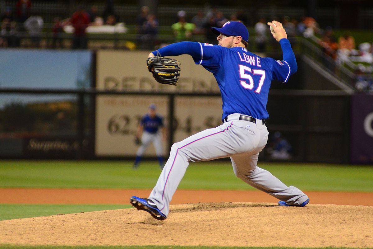 Mar 28, 2012; Surprise, AZ, USA; Texas Rangers relief pitcher Mark Lowe (57) pitches against the Kansas City Royals during the seventh inning at Surprise Stadium.  Mandatory Credit: Jake Roth-US PRESSWIRE