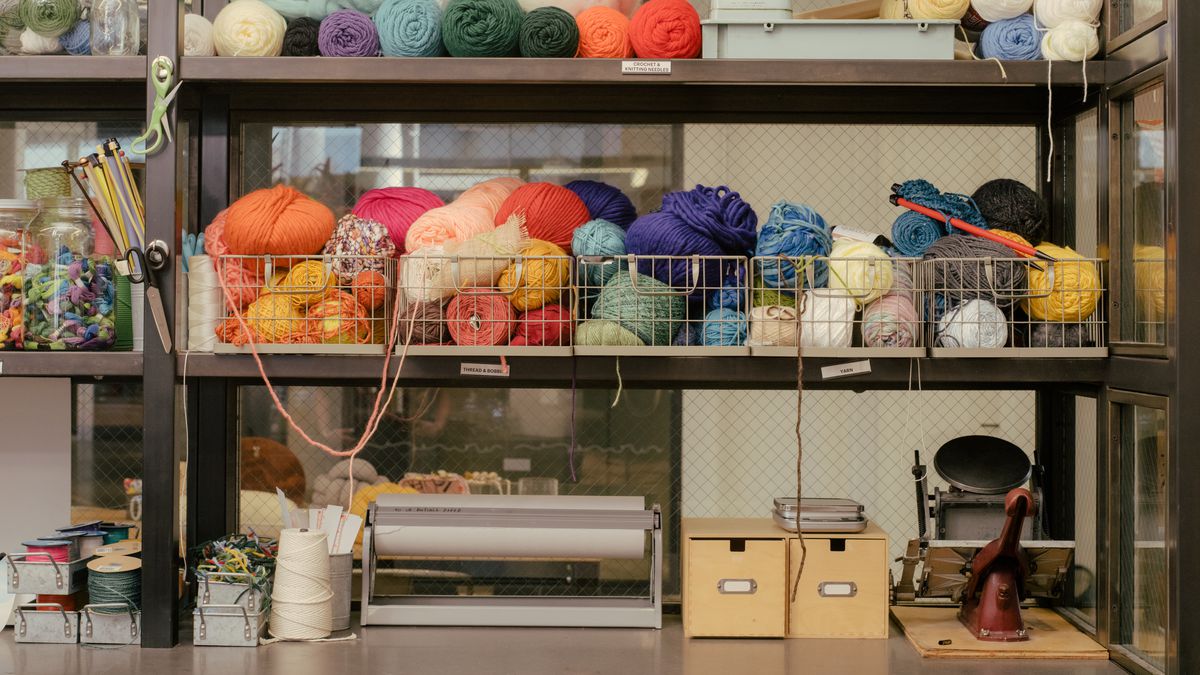 A crafting station at Etsy’s Brooklyn headquarters showing multicolored skeins of yarn and other art supplies.