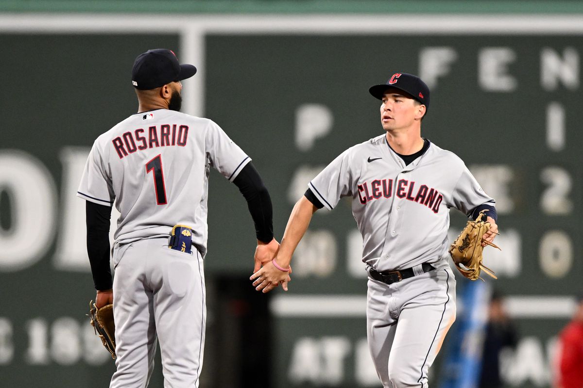 Will Brennan of the Cleveland Guardians high-fives Amed Rosario after a game against the Boston Red Sox at Fenway Park on April 28, 2023 in Boston, Massachusetts.