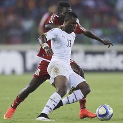 Ghana's Mubarak Wakaso, front, is tackled by Equatorial Guinea's Enrique Boula Senobua, during their African Cup of Nations Semifinals soccer match at Estadio De Malabo, Equatorial Guinea, Thursday Feb. 5, 2015. 