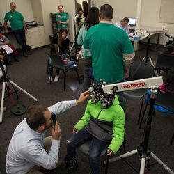 Dr. Lyndon Tyler gives Corbin Fegley, 9, an eye exam during SightFest at the Jordan School District Auxiliary Services building in West Jordan on Thursday, Dec. 8, 2016. SightFest is a partnership between Friends for Sight and the Utah Optometric Association that on Thursday provided free eye exams and glasses for 125 students from Title I schools in the Jordan School District.