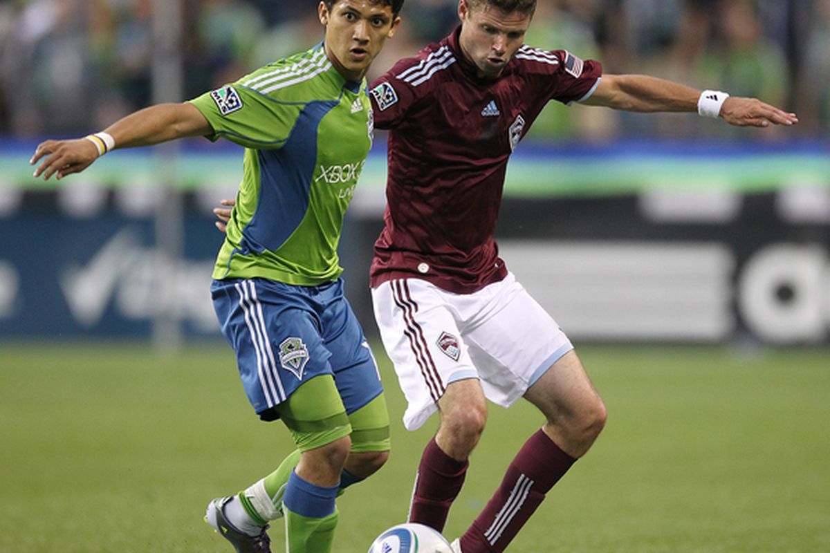 SEATTLE - JULY 25:  Fredy Montero #17 of the Seattle Sounders FC battles Drew Moor #3 of the Colorado Rapids on July 25 2010 at Qwest Field in Seattle Washington. (Photo by Otto Greule Jr/Getty Images)