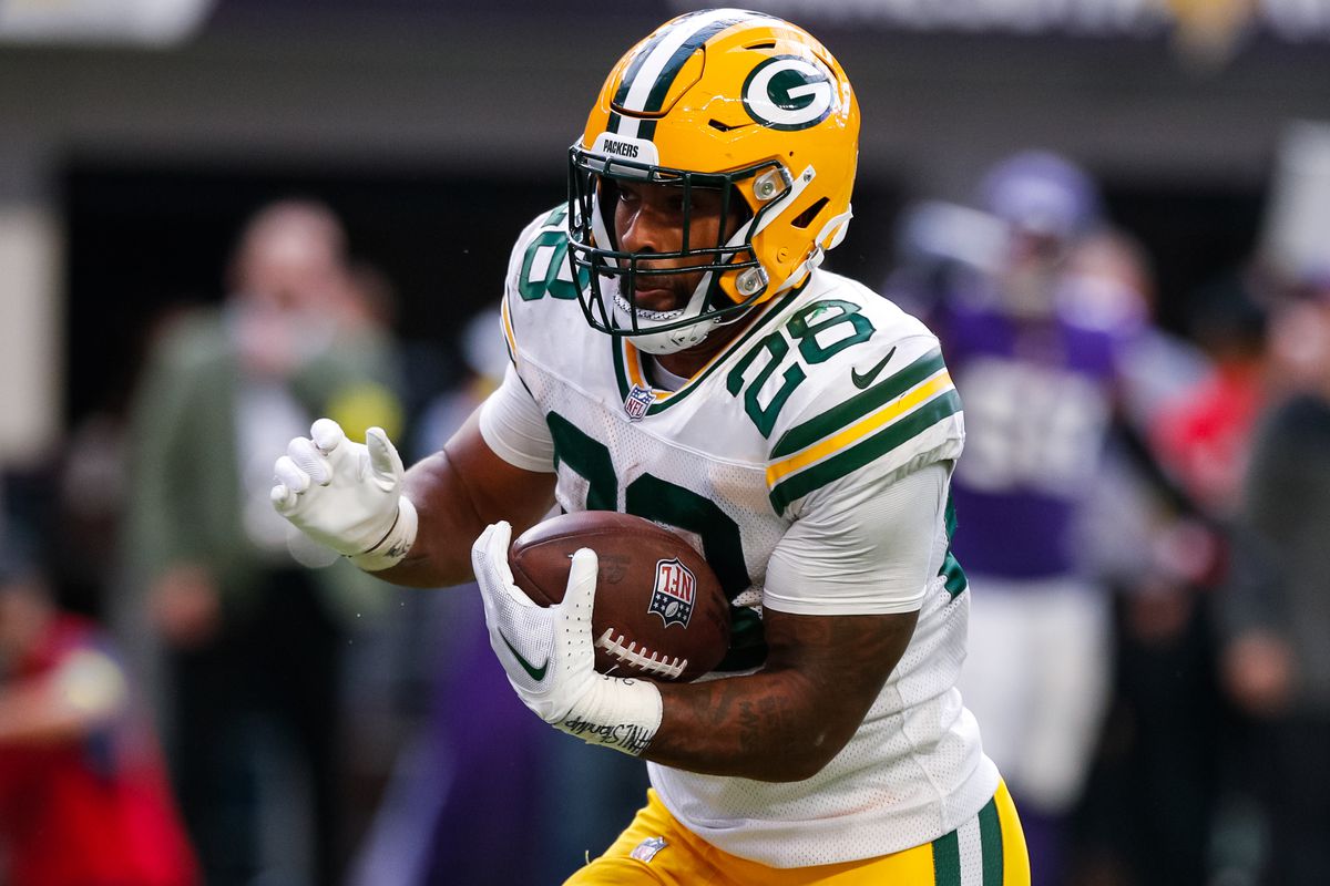 AJ Dillon of the Green Bay Packers runs with the ball against the Minnesota Vikings in the third quarter of the game at U.S. Bank Stadium on September 11, 2022 in Minneapolis, Minnesota. The Vikings defeated the Packers 23-7.