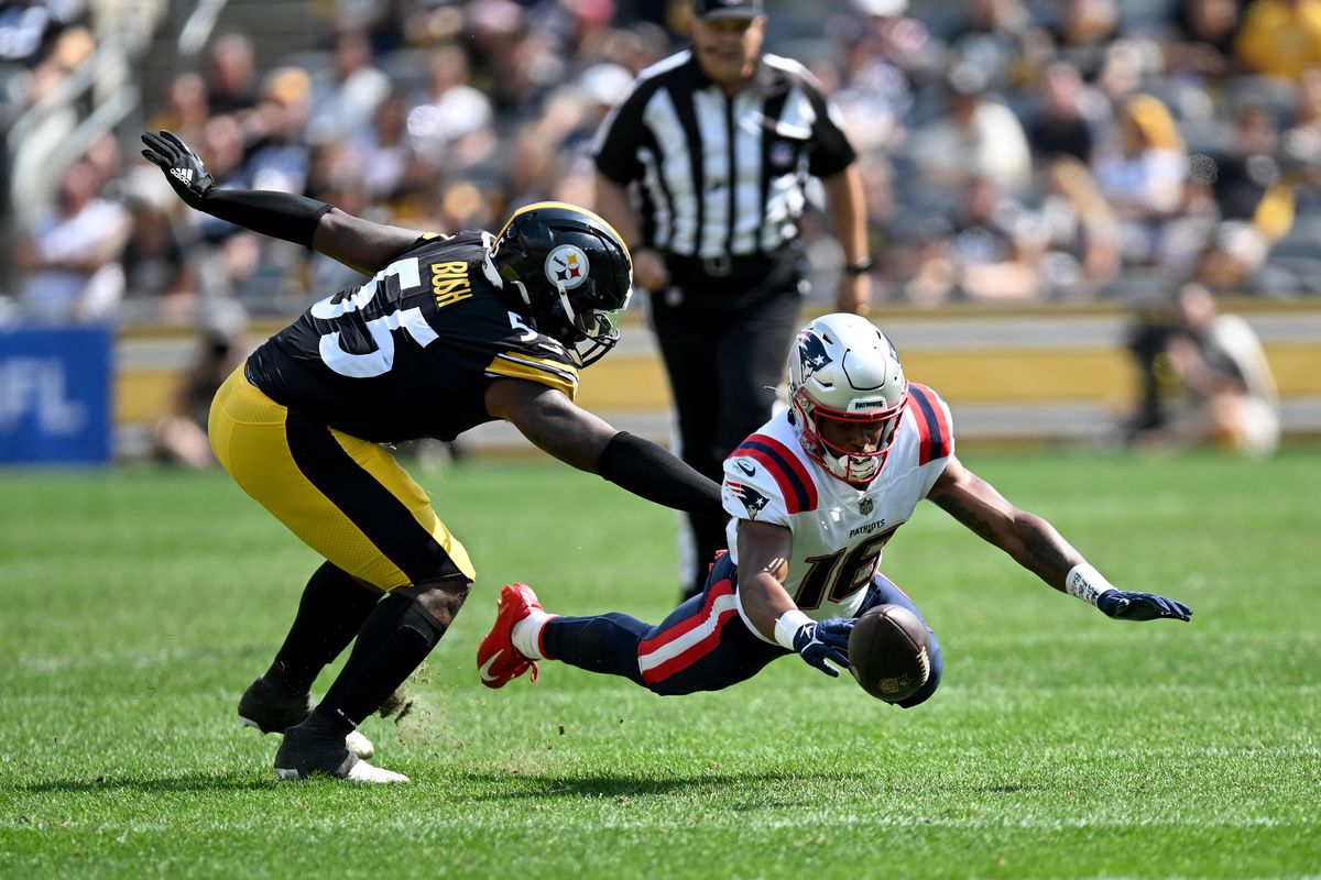 Jakobi Meyers #16 of the New England Patriots attempts to catch a pass while defended by Devin Bush #55 of the Pittsburgh Steelers d1h at Acrisure Stadium on September 18, 2022 in Pittsburgh, Pennsylvania.