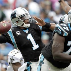 Carolina Panthers' Cam Newton (1) looks to pass against the New Orleans Saints in the first half of an NFL football game in Charlotte, N.C., Sunday, Dec. 22, 2013. 