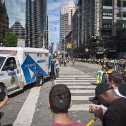 An ambulance arrives to the scene after shots were fired during the Toronto Raptors NBA basketball championship victory celebration near Nathan Phillips Square in Toronto, Monday, June 17, 2019. (Tijana Martin/The Canadian Press via AP)