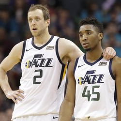 Utah Jazz's Joe Ingles (2) talks with Donovan Mitchell (45) during the second half of an NBA basketball game against the Charlotte Hornets in Charlotte, N.C., Friday, Jan. 12, 2018. (AP Photo/Chuck Burton)