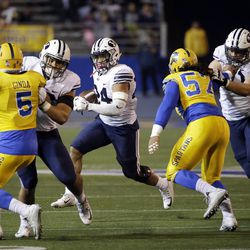 BYU running back Algernon Brown, center, carries against San Jose State during the second half of an NCAA college football game Friday, Nov. 6, 2015, in San Jose, Calif. BYU won 17-16. (AP Photo/Marcio Jose Sanchez)