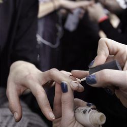 Models have fingernail polish applied backstage before the fall 2010 collection of BCBGMAXAZRIA is presented during Mercedes-Benz Fashion Week, in New York,  Thursday, Feb. 11, 2010. 