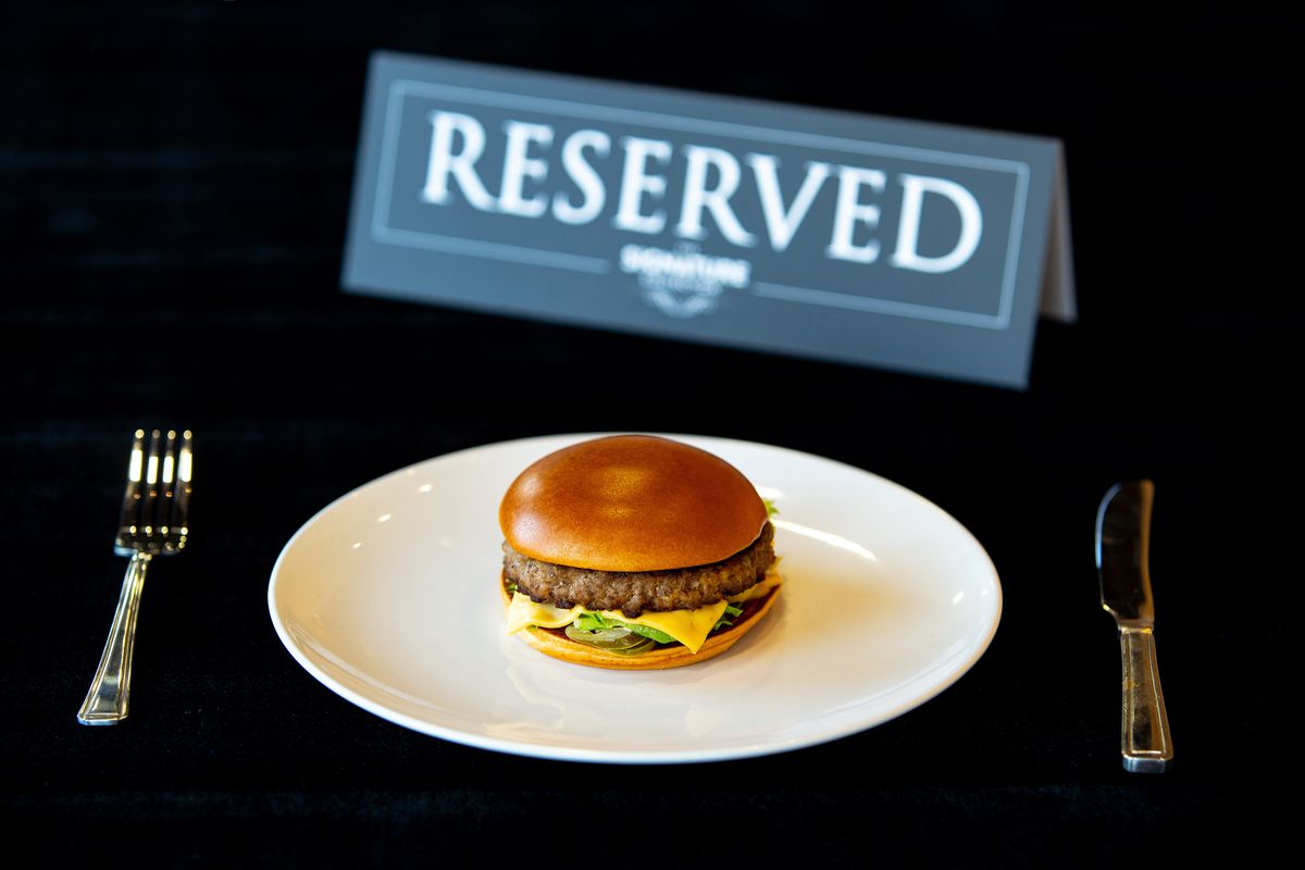 McDonald’s U.K. has taken the signature collection burger off its menu, pictured here with a “reserved” sign and a knife and fork