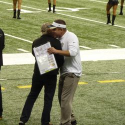 Payton gives Jimmy Buffet a hug as he walks onto the field. 
