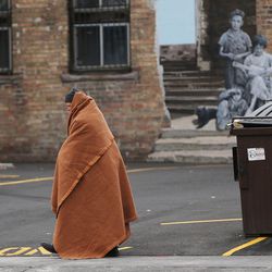 FILE - A homeless person wrapped in a blanked walks the streets of downtown Salt Lake City on Thursday, Dec. 8, 2016.