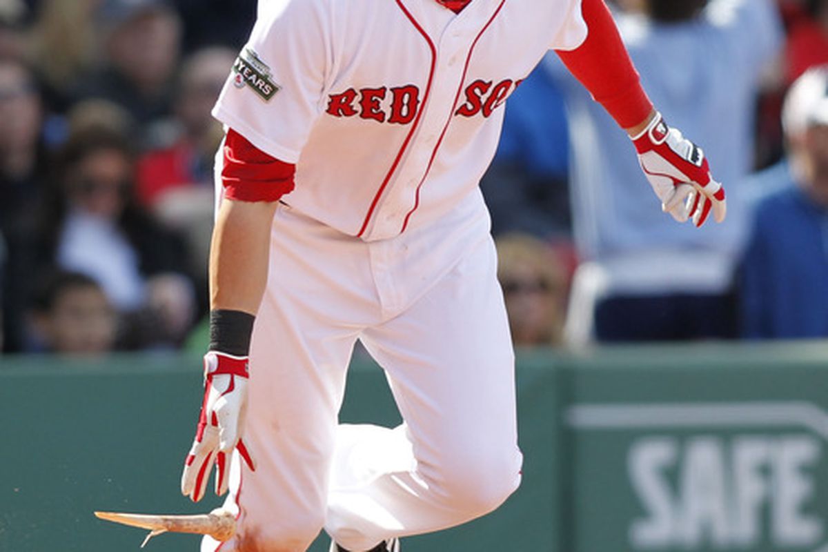 May 6, 2012; Boston, MA, USA; Boston Red Sox right fielder Ryan Sweeney (12) hits a single during the fifth inning against the Baltimore Orioles at Fenway Park.  Mandatory Credit: Greg M. Cooper-US PRESSWIRE
